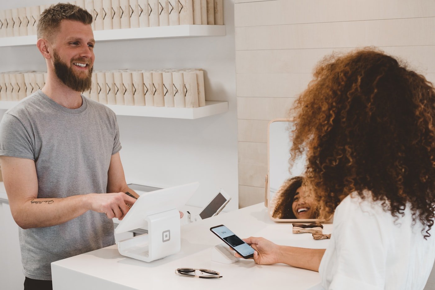 Business owner accepting a contactless card payment at a POS terminal